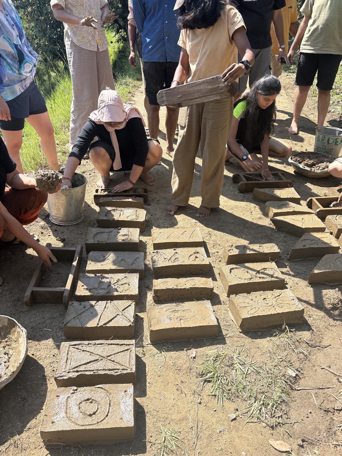 Decorative adobe bricks carved with spiral, sun and infinity motifs
