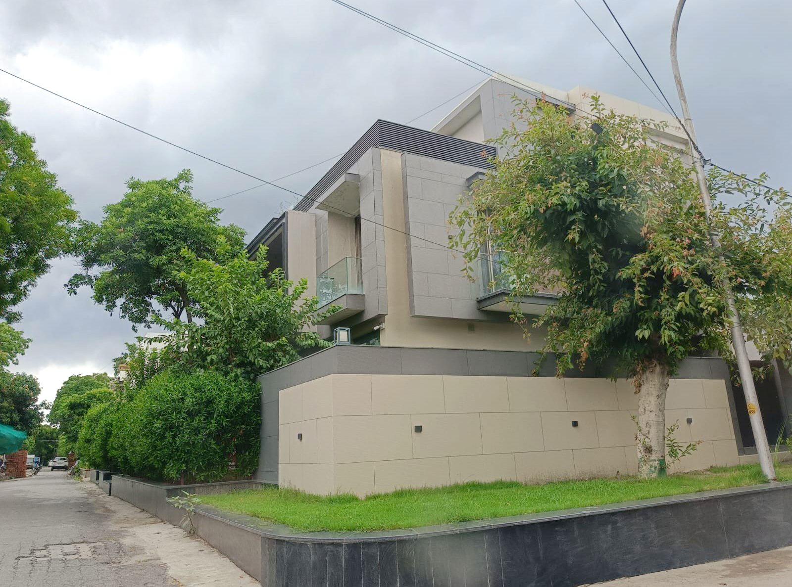 Residence C-1413 — completed corner view with matured landscape